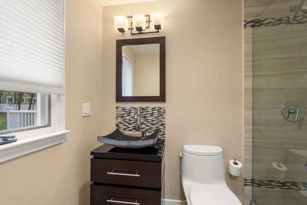 13 Lyndon Road Sharon, MA 02067 - Photo 15 of 29 a bathroom with a toilet sink and mirror