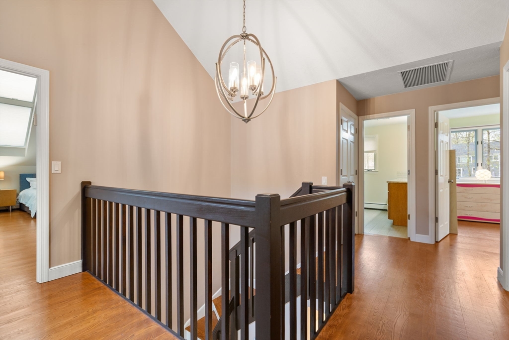 13 Lyndon Road Sharon, MA 02067 - Photo 18 of 29 a view of a hallway with wooden floor and stairs