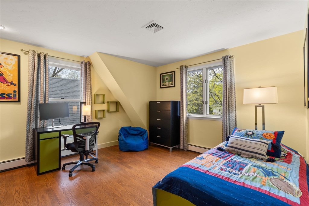 13 Lyndon Road Sharon, MA 02067 - Photo 25 of 29 a bedroom with a bed and a chandelier