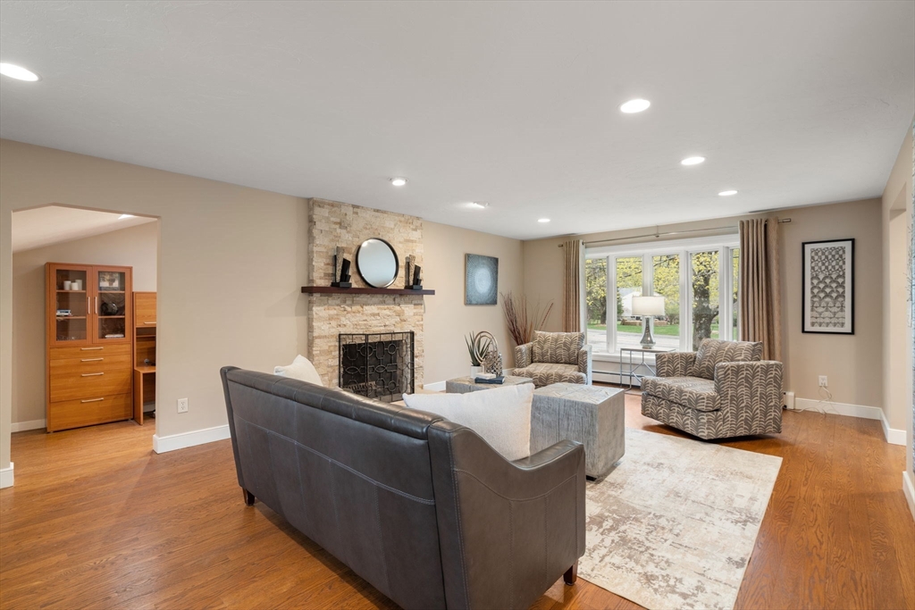 13 Lyndon Road Sharon, MA 02067 - Photo 3 of 29 a living room with furniture a fireplace and a large window