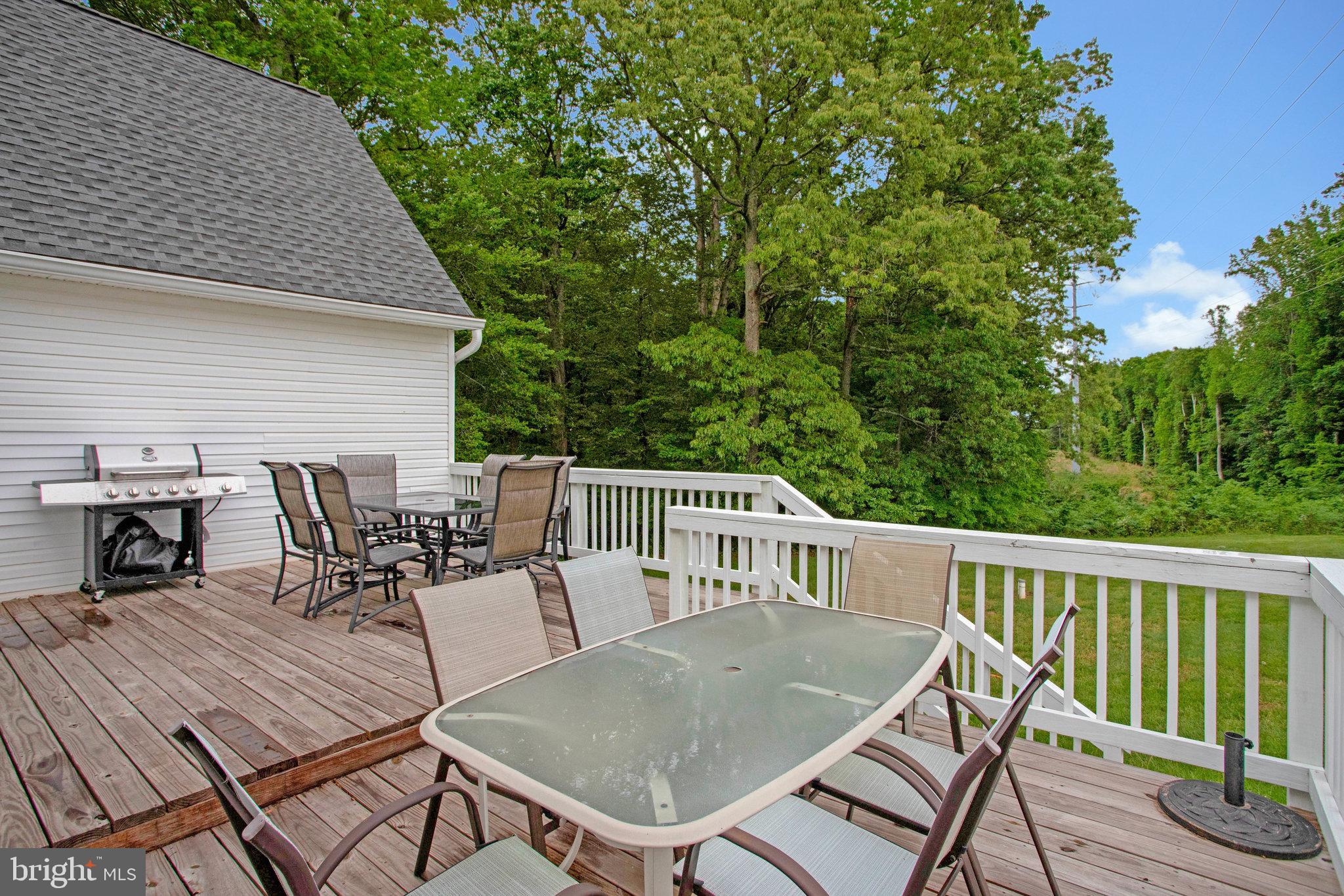 2345 Lowery Road Huntingtown, MD 20639 - Photo 5 of 24 a view of a patio with table and chairs with wooden floor and fence