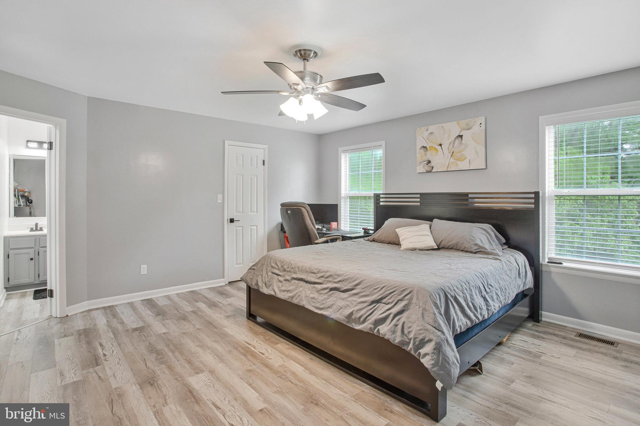 2345 Lowery Road Huntingtown, MD 20639 - Photo 8 of 24 a bedroom with a large bed and a window