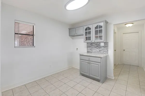 a view of kitchen with white cabinets