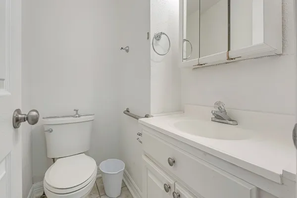 a bathroom with a sink a toilet and vanity