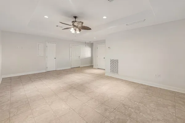 a view of an empty room with a ceiling fan