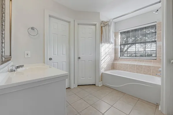 a spacious bathroom with a tub sink and a shower