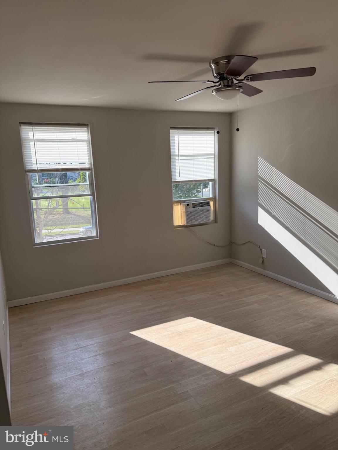 2803 Edison Highway, Unit 2 Baltimore, MD 21213 - Photo 4 of 11 a view of an empty room with wooden floor and a window