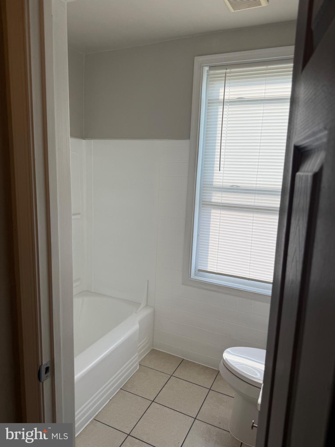 2803 Edison Highway, Unit 2 Baltimore, MD 21213 - Photo 10 of 11 a bathroom with a toilet and a bathtub