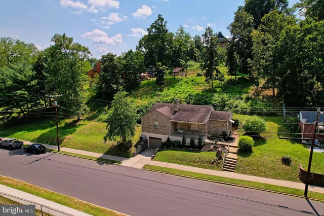 an aerial view of a house with a garden and yard