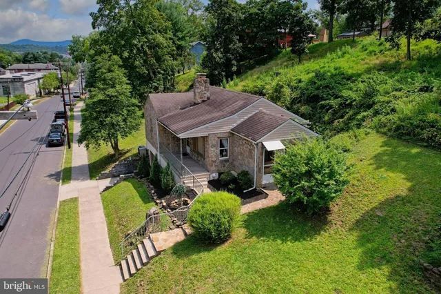 an aerial view of a house with swimming pool garden and patio