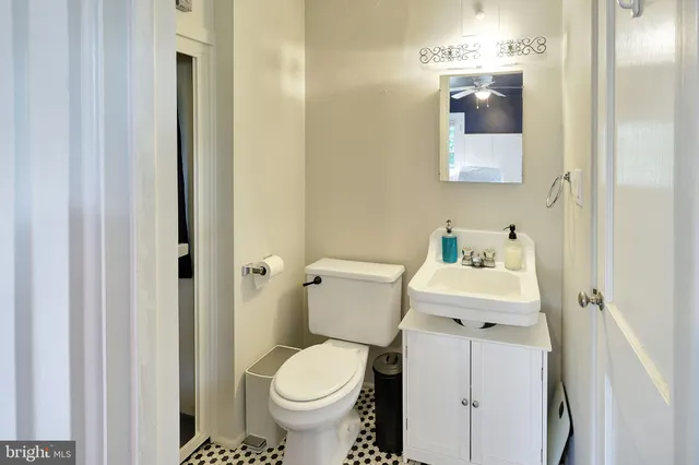 a white toilet sitting next to a bathroom sink