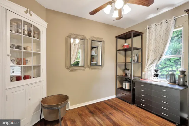 a workspace with wooden floor and windows
