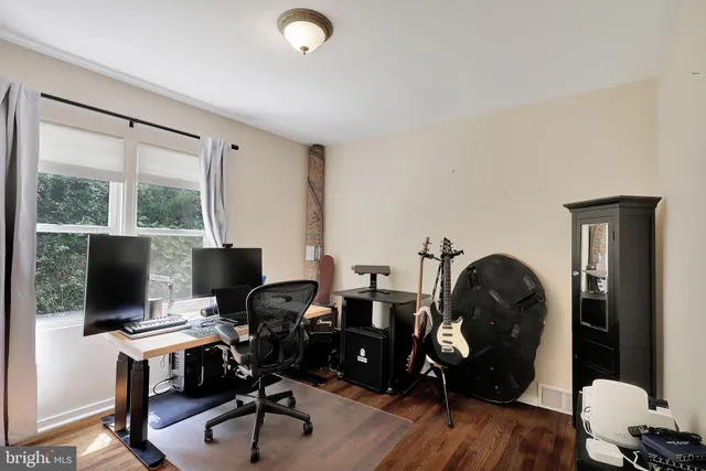 a view of workspace with wooden floor windows