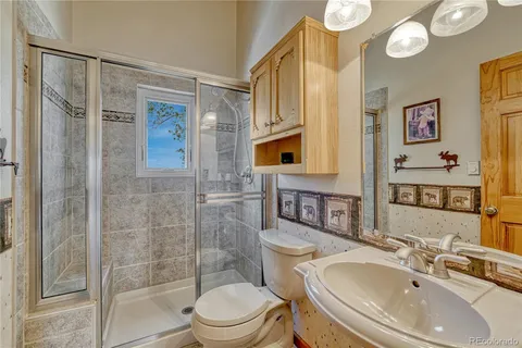 a bathroom with a sink toilet and shower