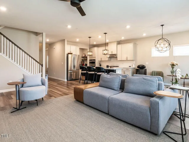 a living room with furniture and a chandelier