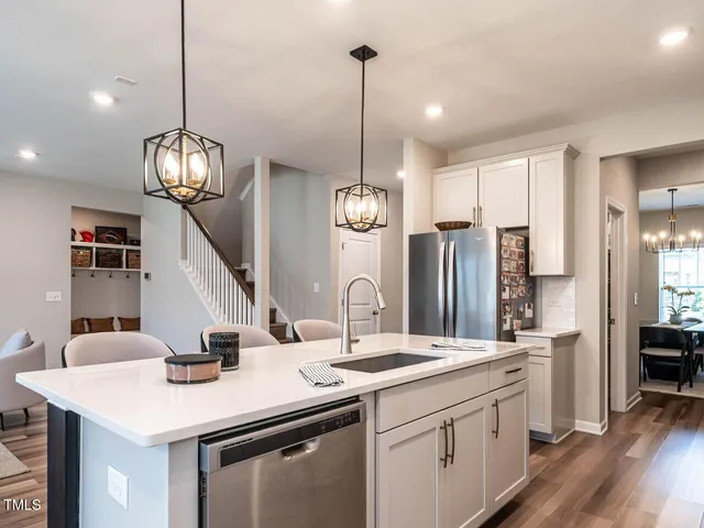 a kitchen with stainless steel appliances kitchen island a large island in the center