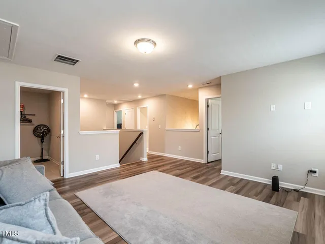 a bedroom with a bed and a large mirror