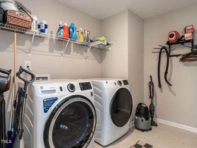 a utility room with dryer washer and closet