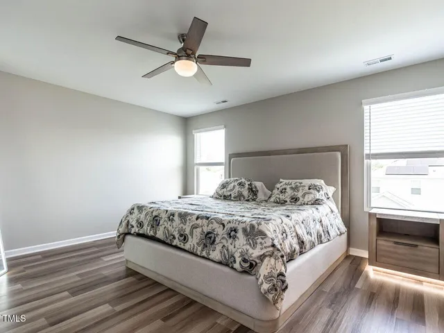 a bedroom with bed and window