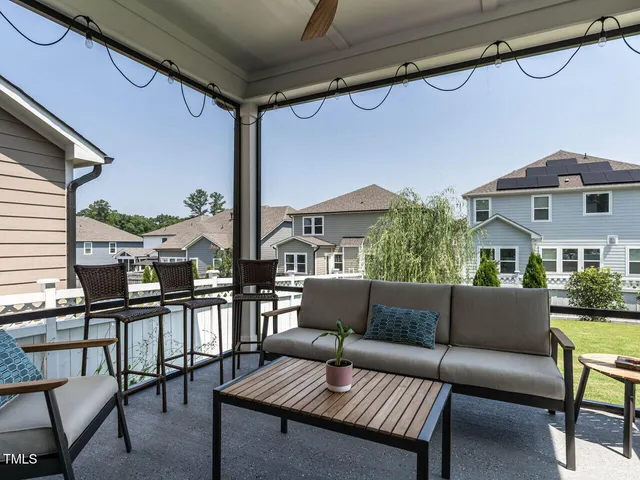 a living room with furniture and a floor to ceiling window