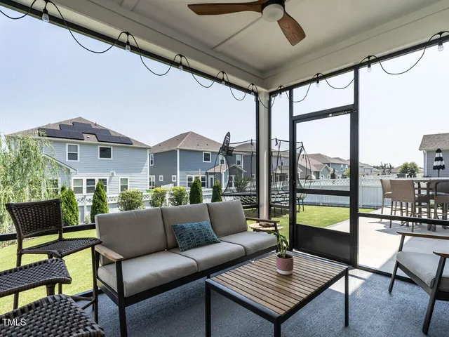 a roof deck with table and chairs a barbeque with potted plants