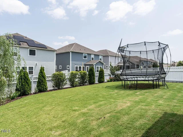 a view of a house with backyard and porch