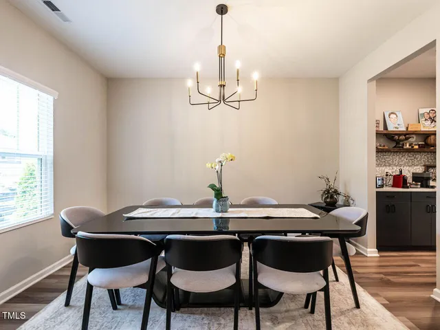 a dining room with furniture and window