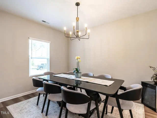 a view of a dining room with a table and chairs