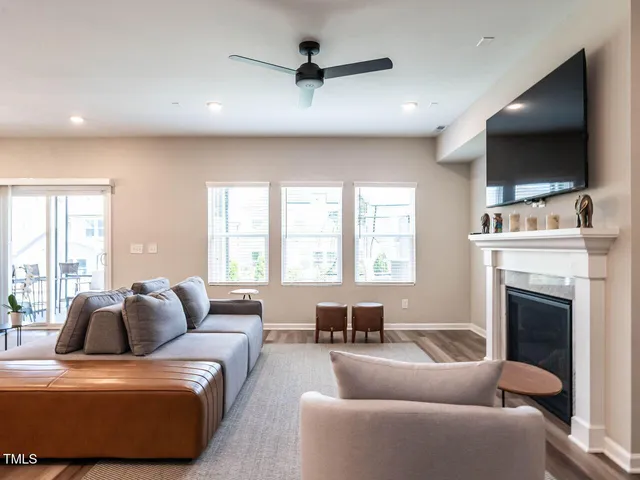 a living room with furniture a flat screen tv and a fireplace