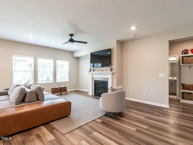 a living room with furniture a fireplace and a flat screen tv