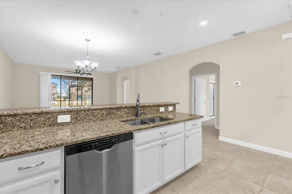 a kitchen with granite countertop a sink and cabinets