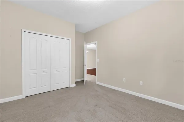a view of an empty room and a bathroom