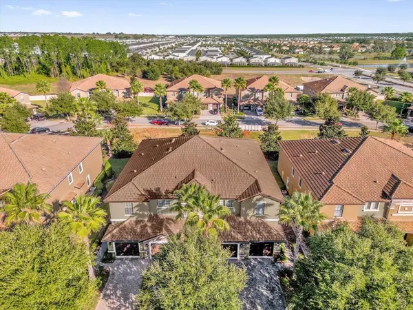 an aerial view of residential houses with outdoor space