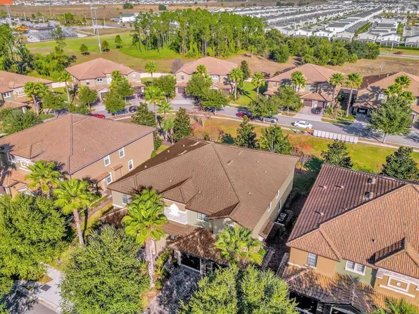 an aerial view of a city with lots of residential buildings ocean and mountain view in back
