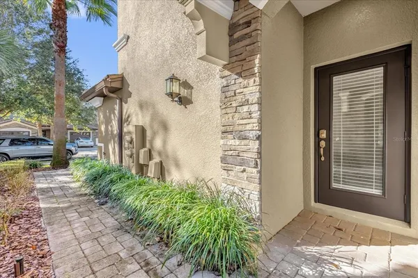 a view of a pathway of house with potted plants