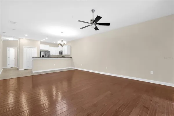 a view of a kitchen with a sink wooden floor and a window