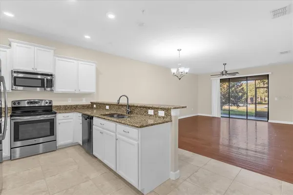 a kitchen with granite countertop a stove and a sink