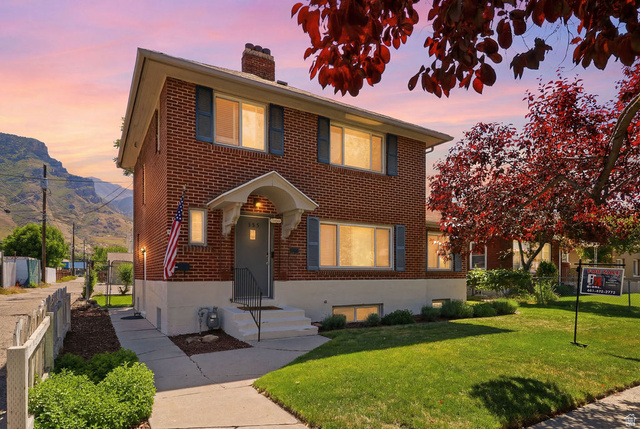 Undisclosed Address Provo, UT 84606 - Photo 1 of 1 Brick two-story residence featuring a covered front entry and a gabled roofline