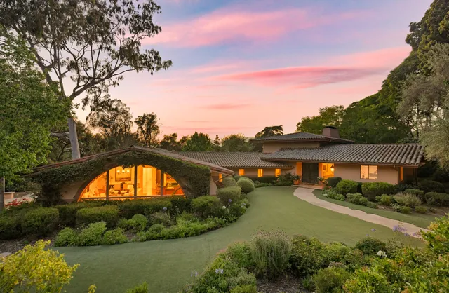 an aerial view of a house with garden space lake and lake view