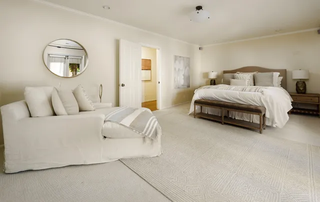 a bedroom with bed and a chandelier