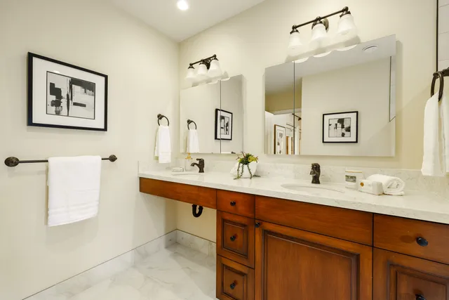 a bathroom with a sink double vanity and a mirror