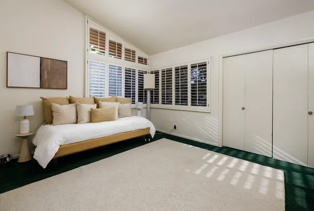 a spacious bedroom with a bed and a window