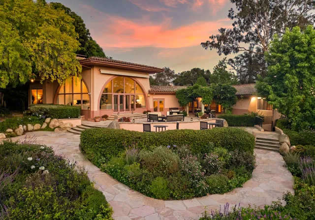 a view of a house with a swimming pool and a garden