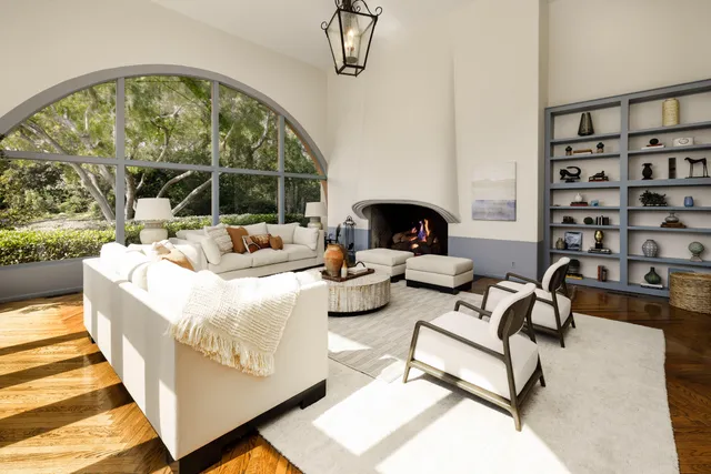 a living room with patio furniture and a large window