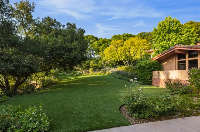 a view of a garden with a building in the background