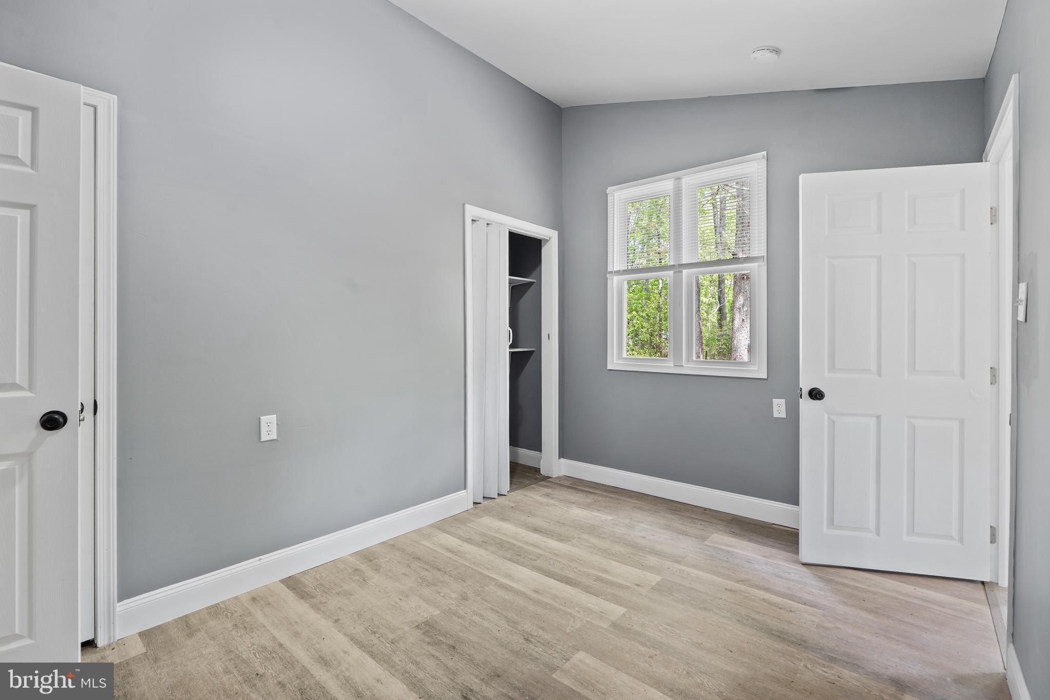 328 Jute Road Millville, NJ 08332 - Photo 15 of 28 a view of an empty room with wooden floor and a window