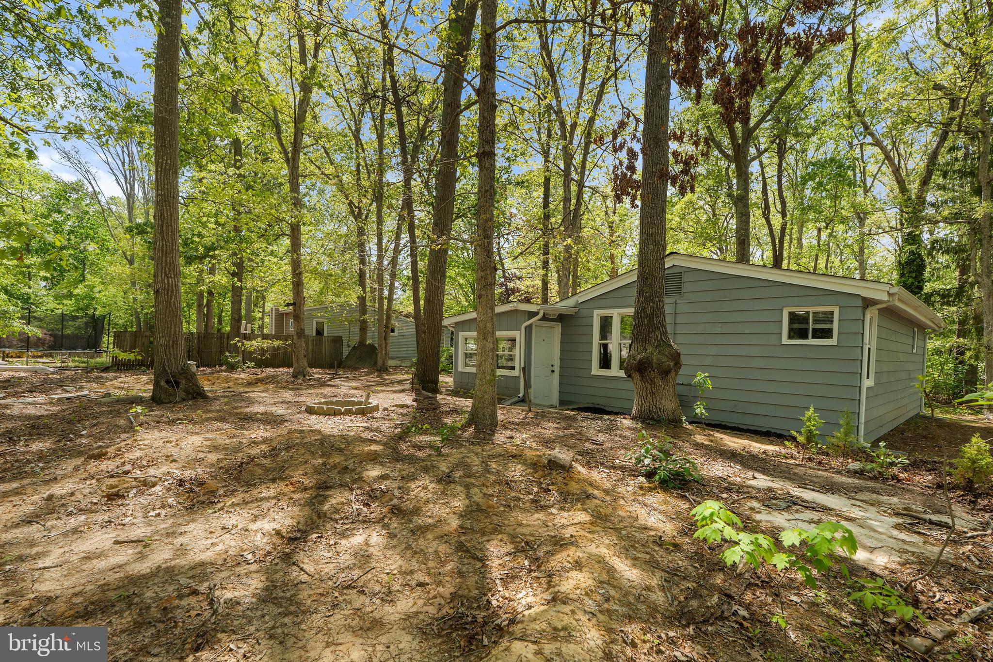 328 Jute Road Millville, NJ 08332 - Photo 27 of 28 a backyard of a house with large trees and wooden fence