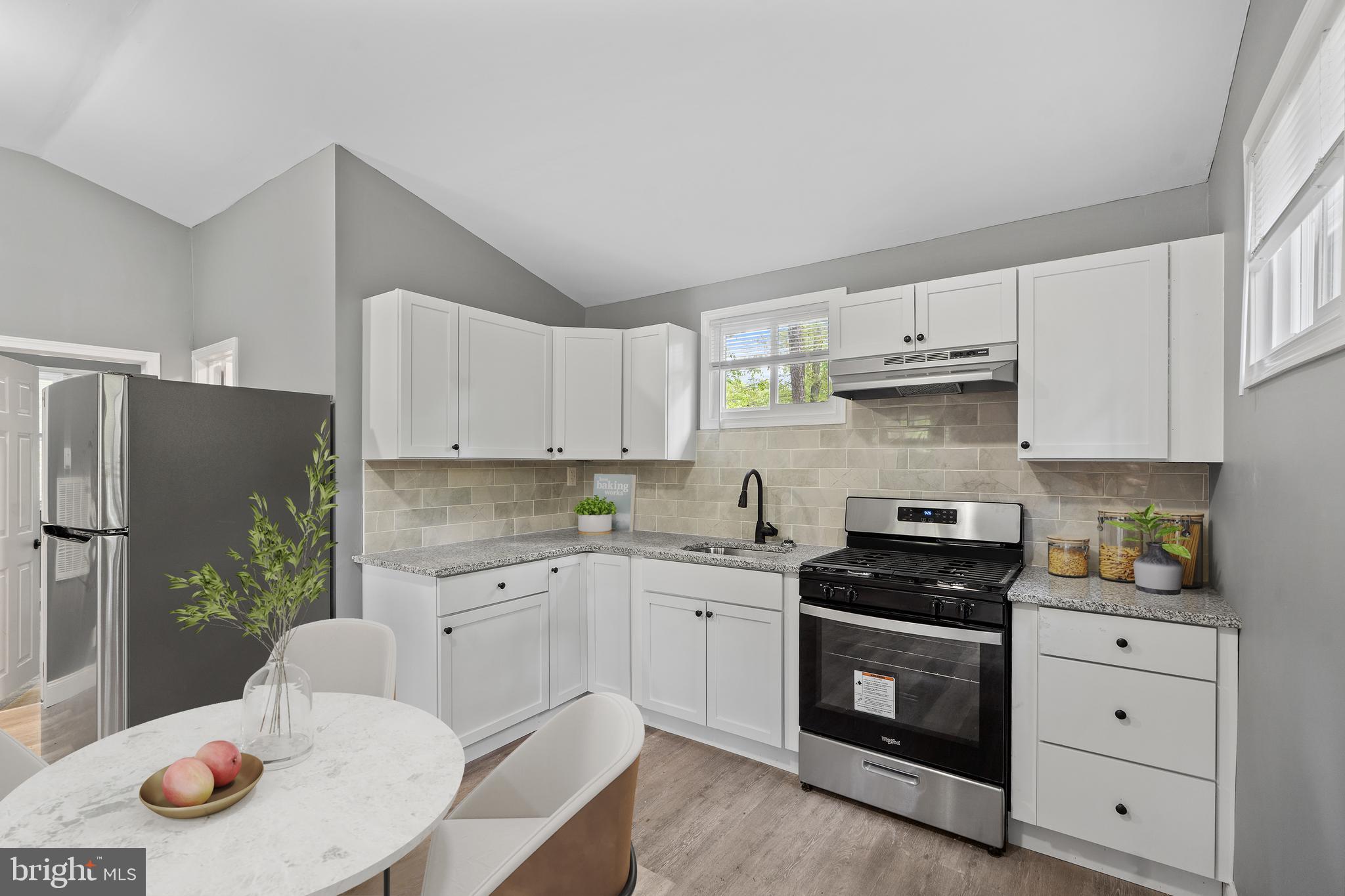 328 Jute Road Millville, NJ 08332 - Photo 9 of 28 a kitchen with stainless steel appliances white cabinets sink and wooden floor