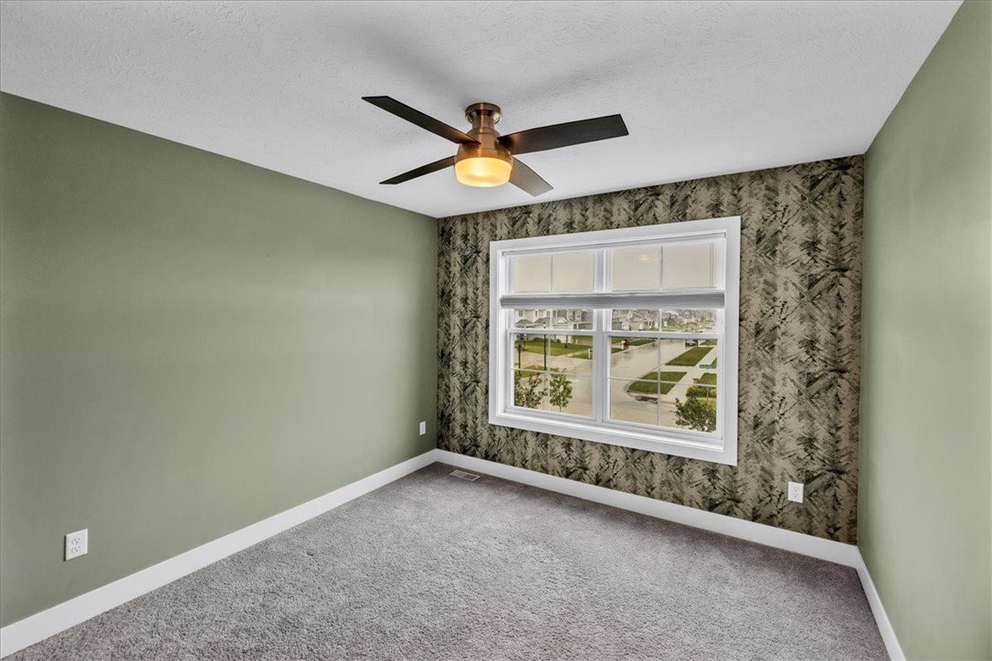 908 Declaration Drive Savoy, IL 61874 - Photo 32 of 41 an empty room with a window and a ceiling fan