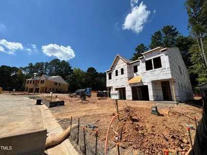 a view of a white house with a yard covered in snow